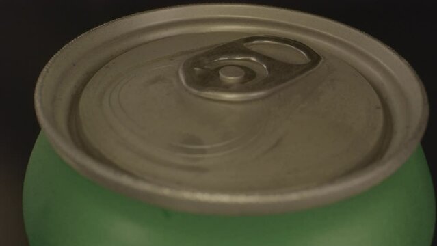 Macro dolly out of top of metal soda can spinning
