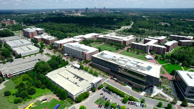 Drone shot of NC State University with the Raleigh skyline in the distance, revealing NCSU campus