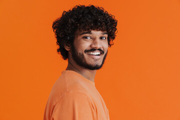 Portrait of young indian handsome curly smiling man