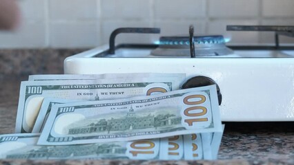 Non renewable energy crisis. A view of money by the working gase stove. A concept of crisis of non renewable energy in the world.