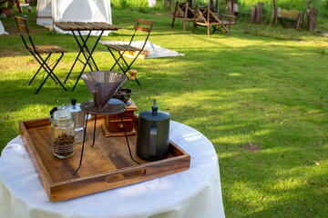 outdoor coffee equipment set Placed on a table with white cloth padding outside the building.