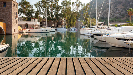 Empty wooden platform on yachts and motor boat in marina port, Aspat Marina. Front view
