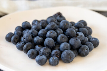 Blueberries on a dark background. Fresh blueberries on the plate. close up