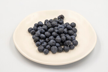 Blueberry isolated on white background. Fresh blueberries on the plate. close up
