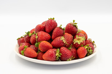 Ripe strawberry isolated on white background. Fresh strawberries on the plate. Organic food. close up