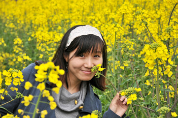 a happy girl in rapeseed field	