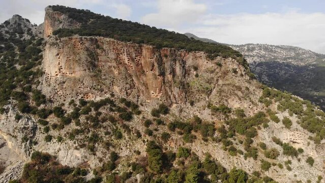 Remains of ancient Lycian rock necropol in Pinara ancient city in Turkey