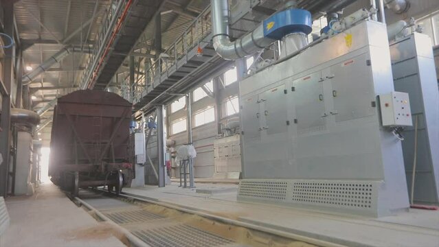 Train inside a modern factory. Train being loaded in the factory shop. The train is in the factory shop.
