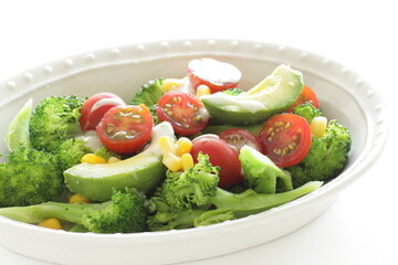 Avocado, cherry tomato, broccoli and sweet corn salad