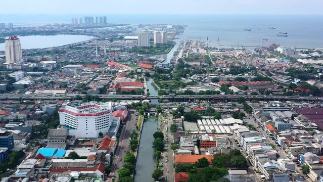 aerial cityscape view of the ocean and Kota Tua in North Jakarta on sunny day