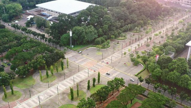 cars driving through the park at GBK Stadium at sunset in Jakarta Indonesia, aerial