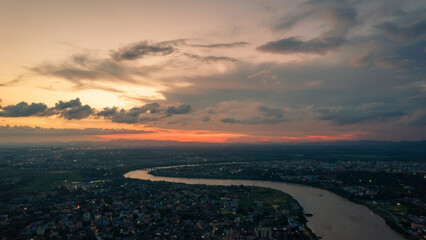 Naklejka na ściany i meble Aerial view of an Indian city with river during twilight