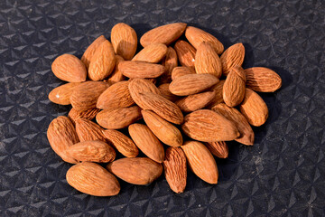 Almonds on wooden table background. Close up
