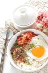 Korean food, barbecue beef and kimchi with sunny side up fried egg on rice for comfort food image 