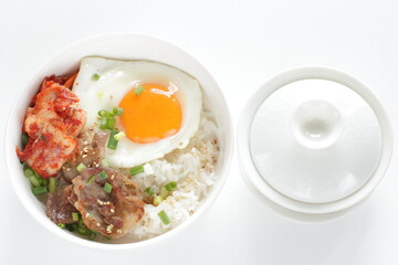 Korean food, barbecue beef and kimchi with sunny side up fried egg on rice for comfort food image 