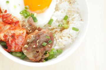 Korean food, barbecue beef and kimchi with sunny side up fried egg on rice for comfort food image 