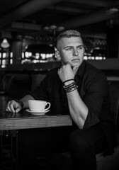 Young stylish Nordic blonde guy, portrait of modern youth. Confident boy with stylish clothes and accessories