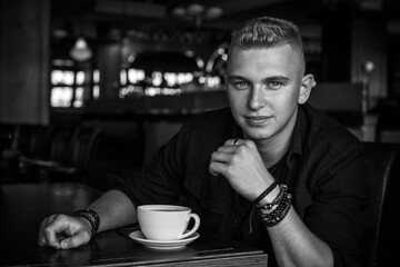 Young stylish Nordic blonde guy, portrait of modern youth. Confident boy with stylish clothes and accessories