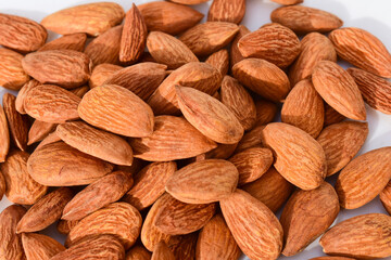 Almonds on wooden table background. Close up
