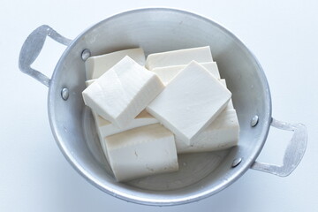 chopped tofu in stainless steel pan for cooking ingredient