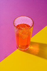 Glass of fresh cocktail on color background
