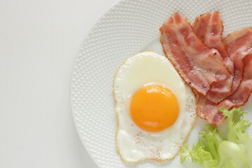 pan fried bacon and sunny side up fried egg for breakfast menu