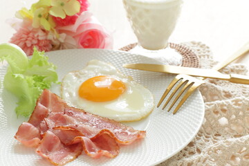 pan fried bacon and sunny side up fried egg for breakfast menu