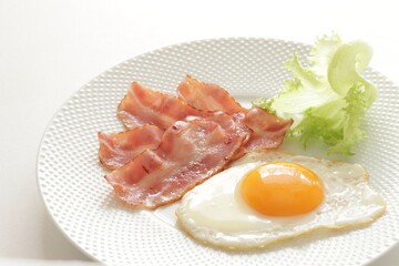 pan fried bacon and sunny side up fried egg for breakfast menu
