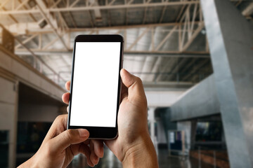 businessman holding smartphone in her office room.