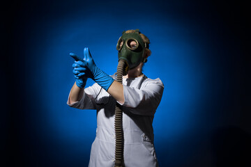 doctor woman in a gas mask folded her hands in the shape of a gun on a blue background