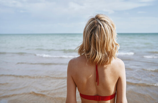 Woman in blond hair looking at sea