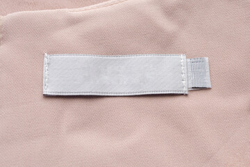 Blank laundry care clothes label on fabric texture background
