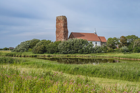 Germany, Schleswig-Holstein, Pellworm, Lake in front of Old Church of Saint Salvator