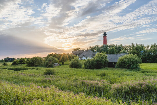 Germany, Schleswig-Holstein, Pellworm, Pellworm Lighthouse and surrounding landscape at springtime sunset