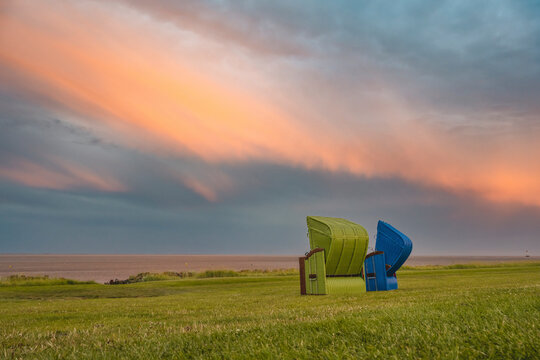 Germany, Schleswig-Holstein, Pellworm, Two hooded beach chairs at dusk