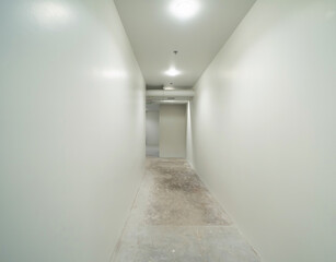 Empty white room corridor, walls and stone marble flooring, interior design decoration background. Loft style under construction.