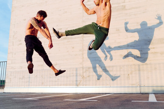 Young Men Practicing Fly Kick Outdoors