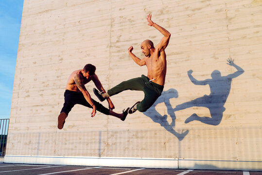 Young men practicing fly kick outdoors