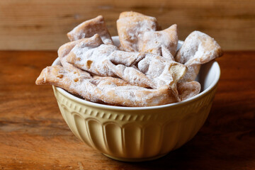 Fat Thursday celebration - traditional Angel Wings cookies decorated with powdered sugar.