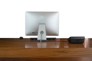 A Modern aluminum desktop personal computer with wireless keyboard, mouse, telephone on the wood table isolated white. background.