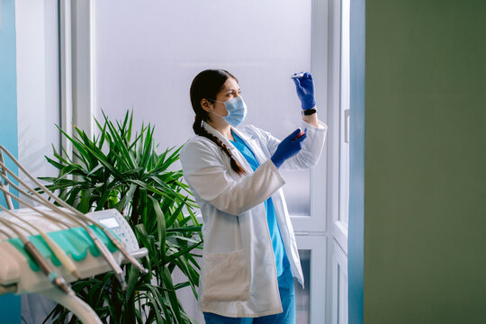 Dentist in uniform with braces in clinic
