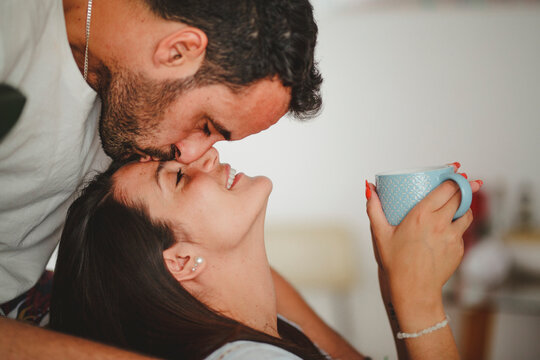 Latin couple hugging at home