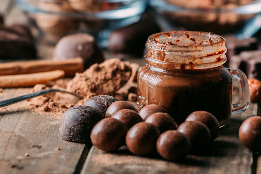 Tasty chocolate sweets and butter arranged on table with cocoa powder