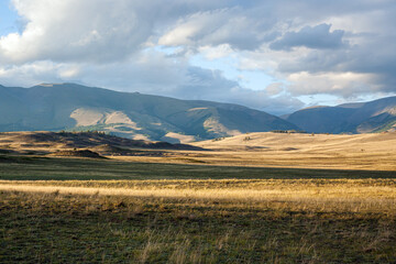 Steppe against the backdrop of mountains in the sunset light