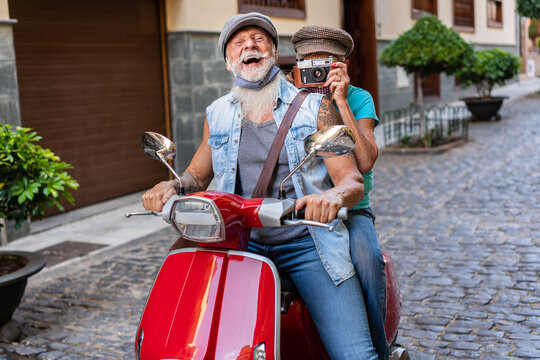 Senior couple riding on a red motorcycle