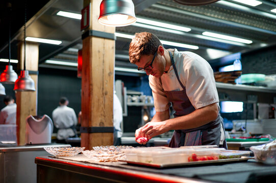Chef serving meal in dishes