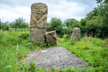 This is a bronze age stone carviing with two faces,called Janus, located In Caldragh Cemetery on Boa Island, Lower Lough Erne. Northern Ireland
