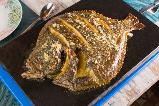 Tasty turbot fish on table in cafe