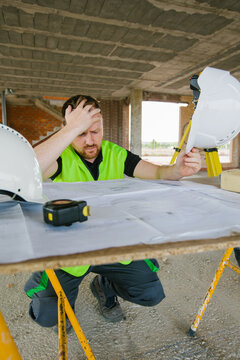 Surveyor engineer working at construction site with measuring eq