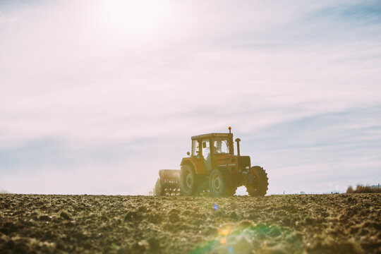 Old tractor working on the field